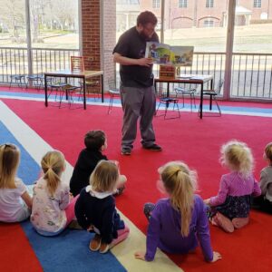 picture of corinth librarian Cody Daniel telling a story during storytime